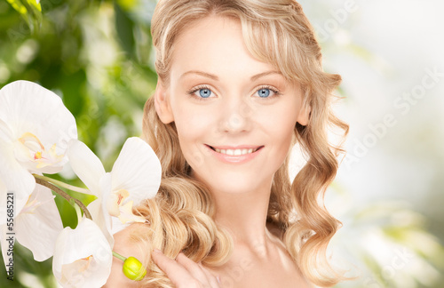 Photo: beautiful woman with orchid flower beautiful woman with orchid flower