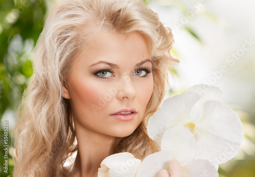 Photo: beautiful woman with orchid flower beautiful woman with orchid flower