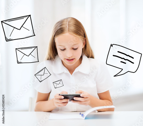 Photo: girl with smartphone at school girl with smartphone at school