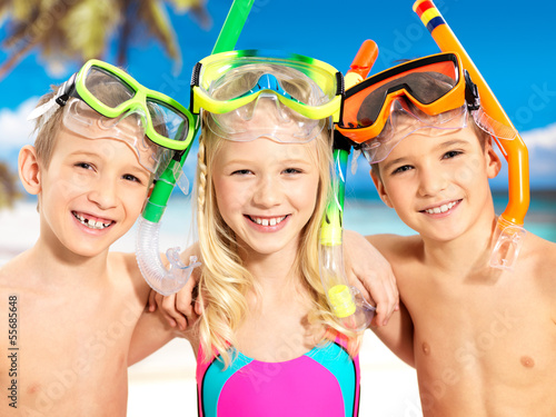 Photo: Portrait of the happy children enjoying at beach Portrait of the happy children enjoying at beach