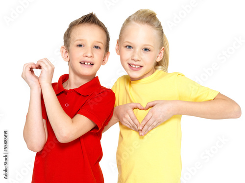 Photo: happy children with a sign of heart shape happy children with a sign of heart shape