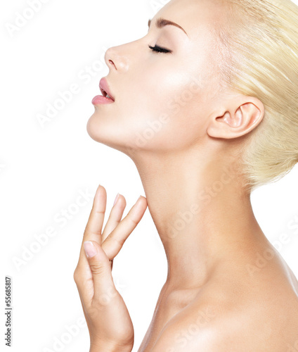 Photo: beautiful woman who touches the neck by fingers beautiful woman who touches the neck by fingers