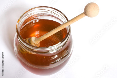 Photo: Honey dipper in a jar of honey close up Honey dipper in a jar of honey close up