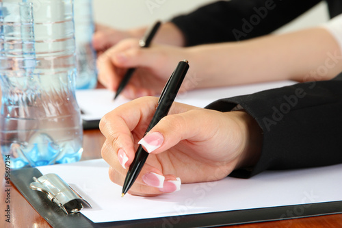Photo: Close up of business people hands during teamwork Close up of business people hands during teamwork