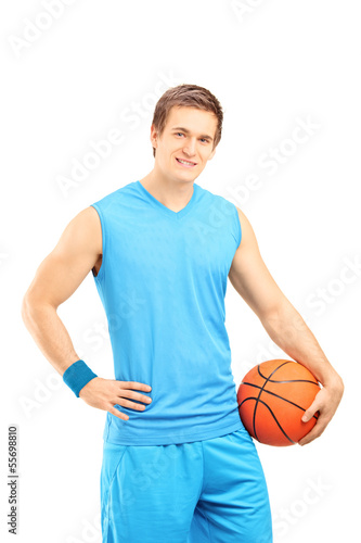 Photo: Basketball player holding a ball and looking at a camera Basketball player holding a ball and looking at a camera