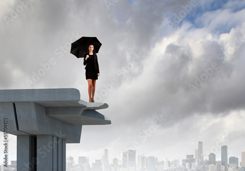 Photo: Businesswoman standing on bridge Businesswoman standing on bridge