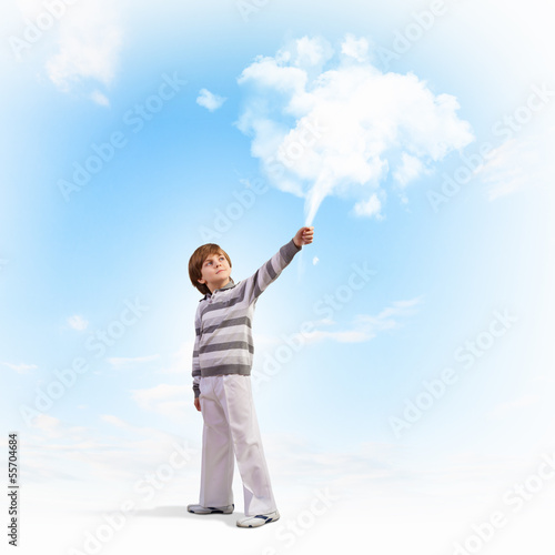 Photo: Cute boy catching clouds Cute boy catching clouds