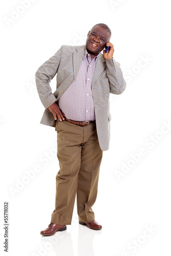 Photo: elderly african man talking on mobile phone elderly african man talking on mobile phone