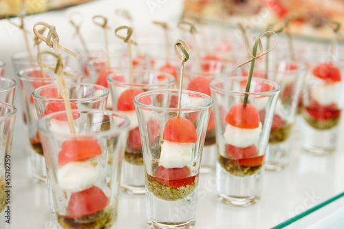 Photo: Various snacks in plate on banquet table Various snacks in plate on banquet table