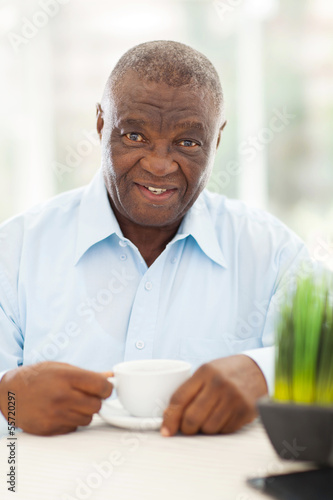 Photo: elderly african american man having coffee elderly african american man having coffee