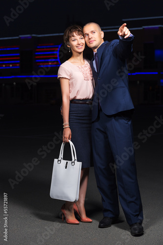 Photo: Happy young couple in love on the night city street Happy young couple in love on the night city street