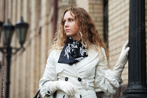 Photo: Sad beautiful woman at lamppost Sad beautiful woman at lamppost