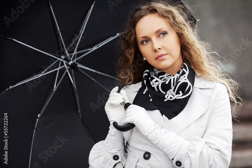Photo: Sad beautiful woman with umbrella Sad beautiful woman with umbrella