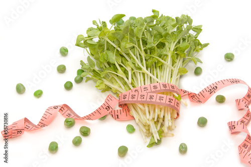 Photo: Snow Pea Sprouts with measuring tape (dieting concept) Snow Pea Sprouts with measuring tape (dieting concept)