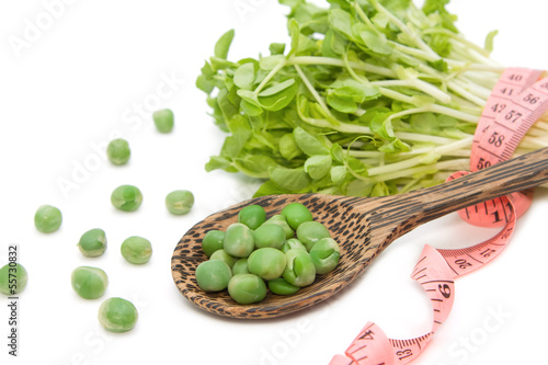 Photo: Green pea with snow pea sprouts and measuring tape dieting conce Green pea with snow pea sprouts and measuring tape dieting conce