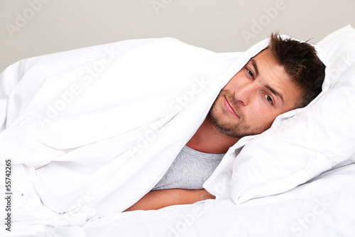 Photo: Handsome young man in bed Handsome young man in bed