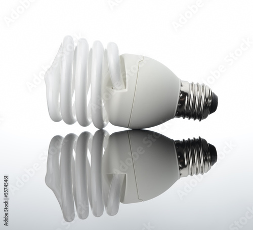 Photo: Energy saving light bulb with reflection Energy saving light bulb with reflection
