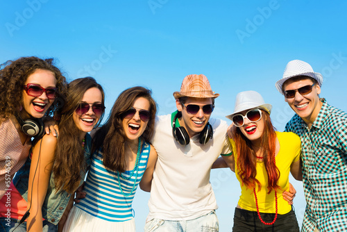 Photo: group of young people wearing sunglasses and hat group of young people wearing sunglasses and hat