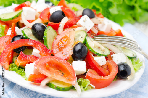 Photo: Greek salad with feta cheese, olives and vegetables, horizontal Greek salad with feta cheese, olives and vegetables, horizontal