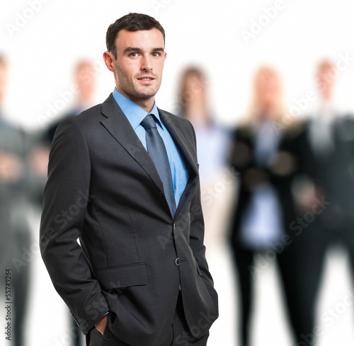 Photo: Businessman in front of his team Businessman in front of his team