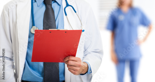 Photo: Doctor holding a clipboard Doctor holding a clipboard