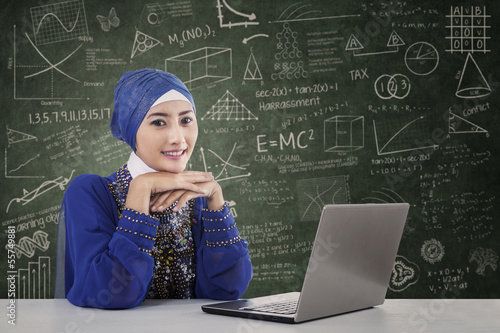 Photo: Beautiful female muslim with laptop in class Beautiful female muslim with laptop in class