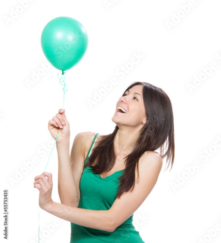 Photo: happy girl with green balloon as a present for birthday party happy girl with green balloon as a present for birthday party