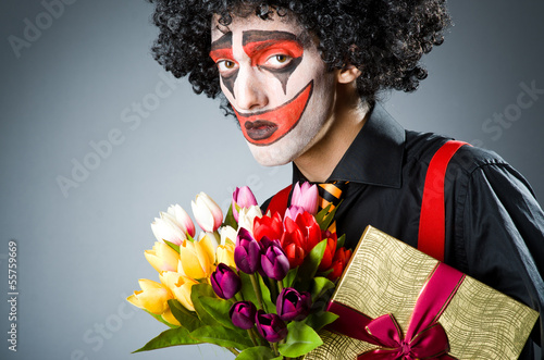 Photo: Sad clown with the flowers Sad clown with the flowers