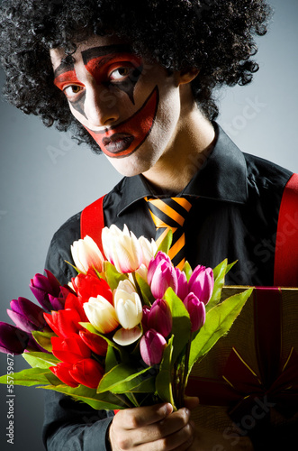 Photo: Sad clown with the flowers Sad clown with the flowers