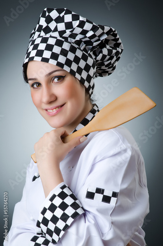 Photo: Pretty cook with kitchen utensils Pretty cook with kitchen utensils
