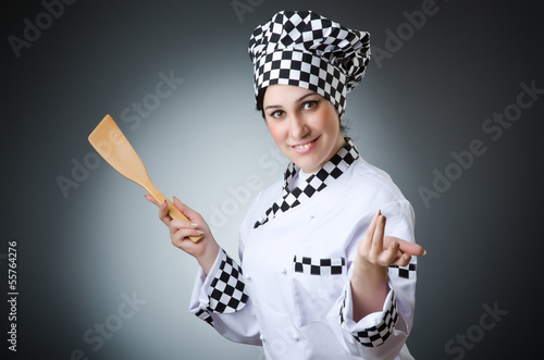 Photo: Pretty cook with kitchen utensils Pretty cook with kitchen utensils