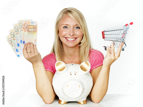 Photo: Woman is happy to save money in piggy bank for shopping Woman is happy to save money in piggy bank for shopping