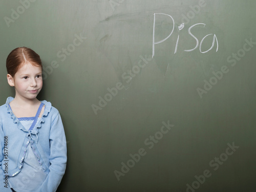 Photo: Mädchen steht an der Tafel in der Schule Mädchen steht an der Tafel in der Schule