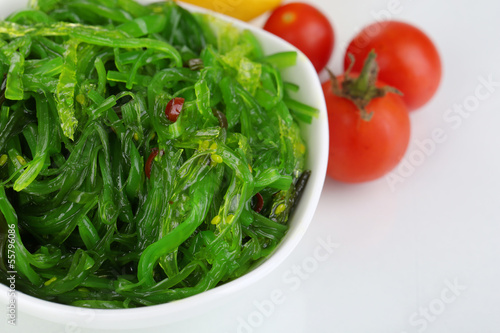 Photo: Sea kale in bowl close-up isolated on white Sea kale in bowl close-up isolated on white