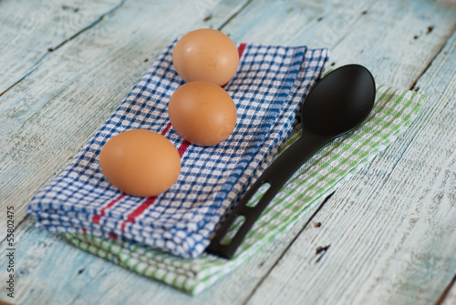 Photo: Eggs with spoon and dish towel Eggs with spoon and dish towel