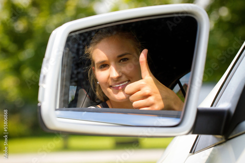 Photo: Female car driver with thumb up Female car driver with thumb up