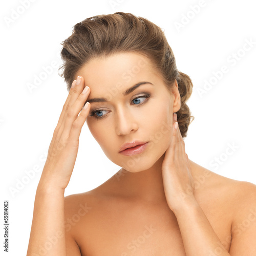 Photo: woman holding hands on her neck and forehead woman holding hands on her neck and forehead