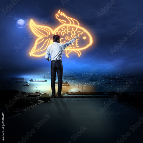 Photo: Businessman drawing gold fish Businessman drawing gold fish