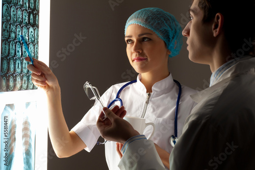Photo: Two doctors examining x-ray results Two doctors examining x-ray results