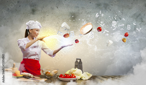 Photo: Asian female cooking with magic Asian female cooking with magic