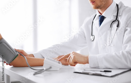 Photo: doctor and patient measuring blood pressure doctor and patient measuring blood pressure