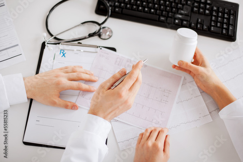 Photo: two doctors prescribing medication two doctors prescribing medication