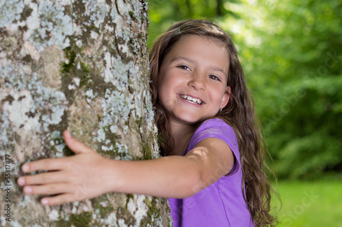 Photo: Kleines Mädchen umarmt Freudestrahlend einen Baum Kleines Mädchen umarmt Freudestrahlend einen Baum