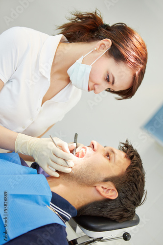 Photo: Dental assistant with male patient Dental assistant with male patient