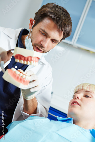Photo: Dentist explaing denture to patient Dentist explaing denture to patient