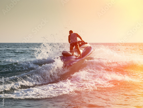 Photo: Silhouette of man on jetski at sea Silhouette of man on jetski at sea