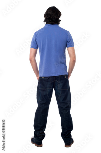 Photo: Casual young man facing the wall Casual young man facing the wall