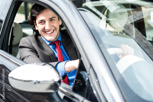 Photo: Smart young businessman driving his new car Smart young businessman driving his new car