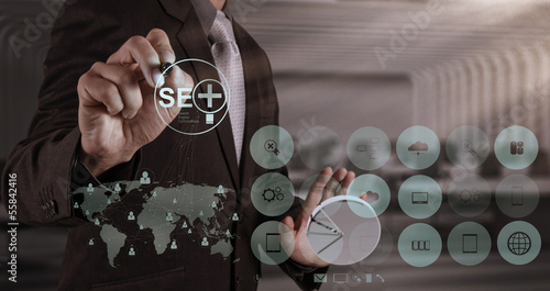 Photo: businessman hand showing search engine optimization SEO businessman hand showing search engine optimization SEO