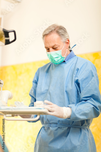 Photo: Dentist working in his office Dentist working in his office